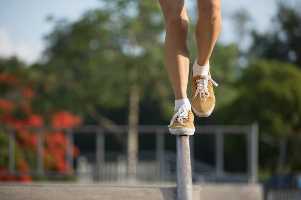 istock Legs walking on steel pipe with balance 965492880