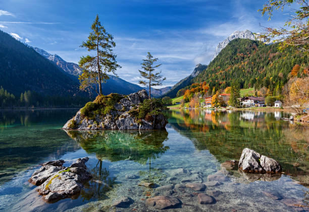 istock Autumn forest reflected in calm lake. Hintersee lake in Berchtesgaden park, Germany. 965496502