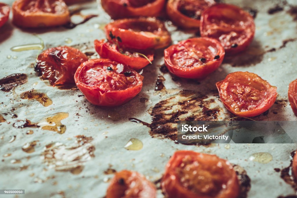 Rustic Style Roasted Cherry Tomatoes on White Baking Parchment Tomato Stock Photo