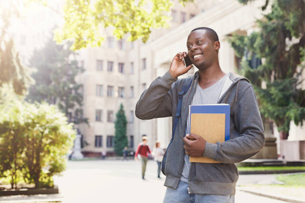 istock Young student talking on smartphone in the park 965500692