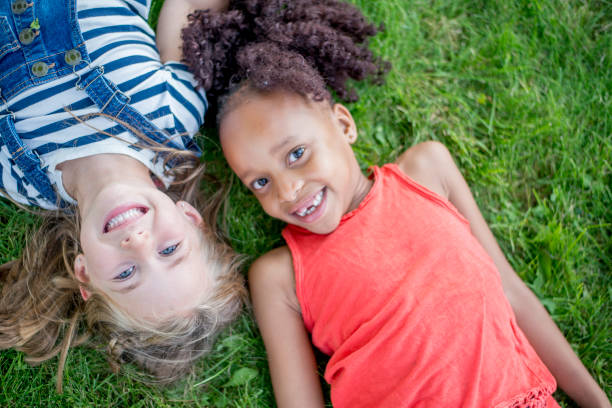 istock Girls Laying In Grass 965503408