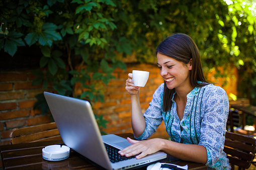 Using laptop in cafe garden