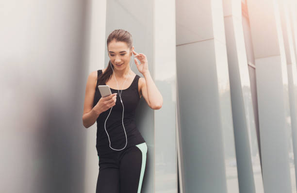 istock Cheerful sporty woman having rest after workout 965504090