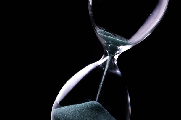 istock Sand running through the bulbs of an hourglass 965508592