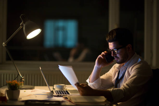 istock Man working with laptop late at night at home 965514588