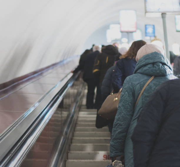 istock People riding the escalator in metro station. 965515518