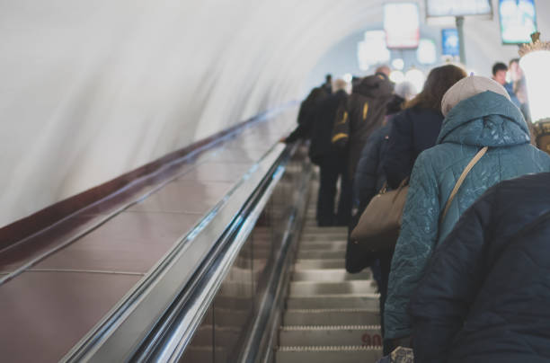 istock People riding the escalator in metro station. 965515530