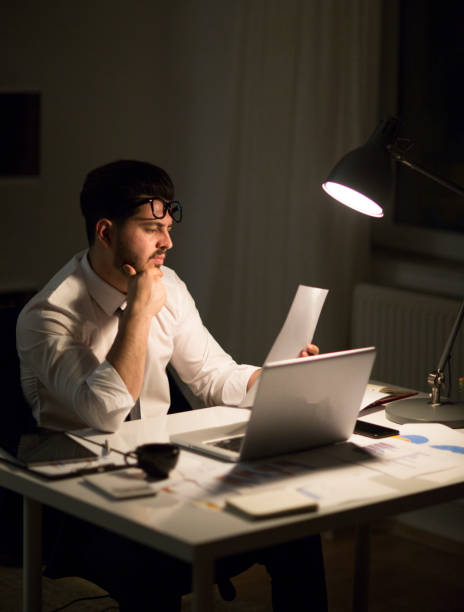 istock Man working with laptop late at night at home 965515668