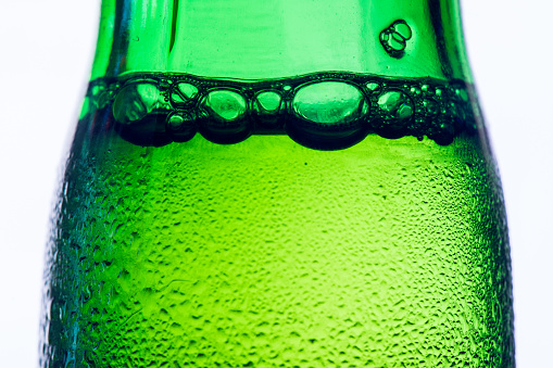 Ice Cold Green Beer Bottle On White Background Closeup High Contrast