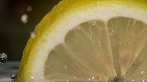 istock Isolated macro of a lemon slice in water background 965515960