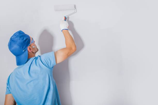 Men Painting His Apartment Caucasian Men Painting His Apartment. Refreshing Room Using Fresh Paint. Construction Theme. house painter ladder paint men stock pictures, royalty-free photos & images