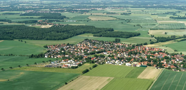 Aerial view from a small airplane from a village near Braunschweig with fields, meadows, farmland and small forests in the area Aerial view from a small airplane from a village near Braunschweig with fields, meadows, farmland and small forests in the area, Germany braunschweig photos stock pictures, royalty-free photos & images