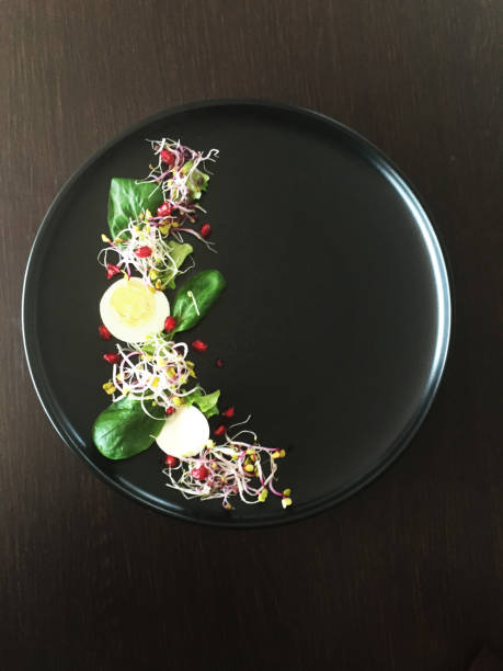 istock Healthy Gourmet Design vegetable salad on black plate 965522800