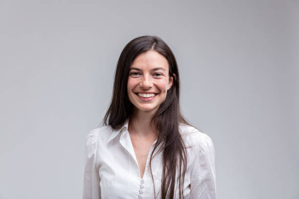 young long-haired smiling woman in white shirt - human face women only women portrait imagens e fotografias de stock