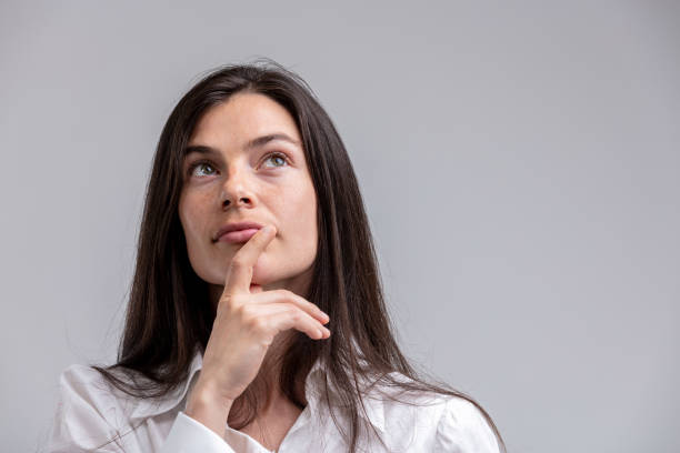 istock Thoughtful woman with her hand to her chin 965523318