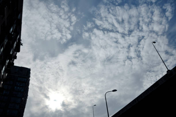 istock Apartment building against blue sky and a street light pole 965527828