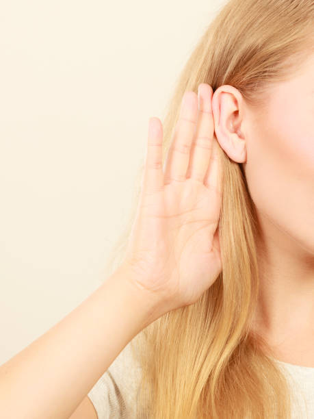 istock Woman putting hand ear to hear better 965529536
