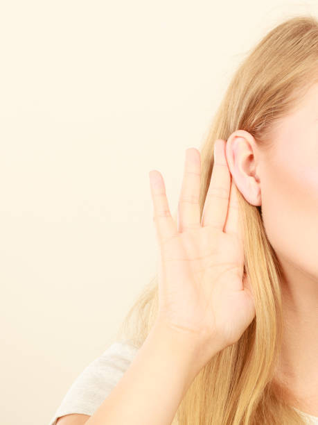 istock Woman putting hand ear to hear better 965532332