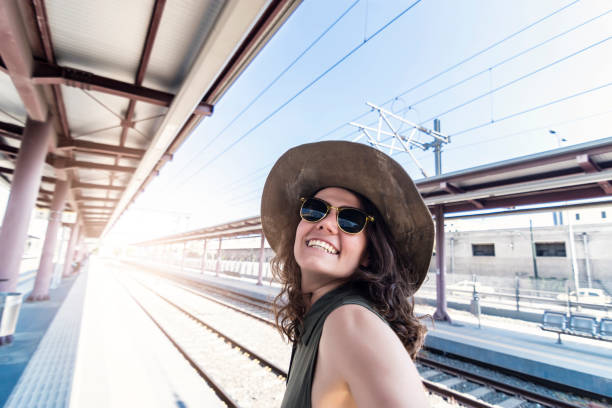 istock Pretty young woman in a train station 965533000
