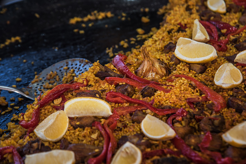 Typical spanish paella in the big traditional pan. Close view. Selective focus.