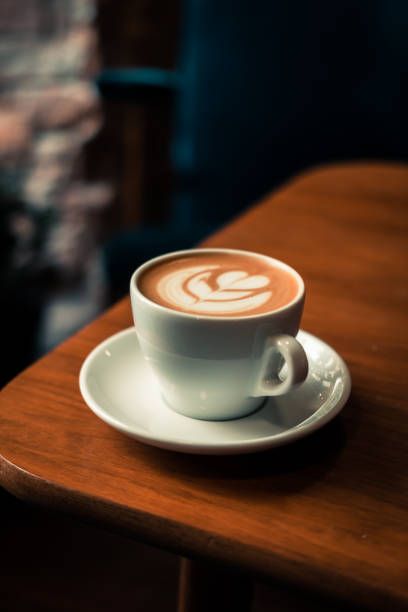 istock Flat white coffee latte art on wooden table 965538632