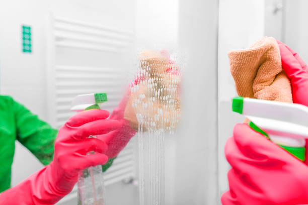 istock Hands in gloves wash the mirror. 965538672