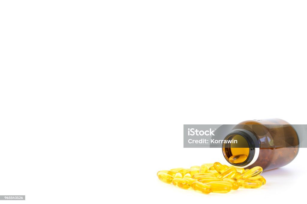 Healthy diet concept.Fish oil capsules with omega 3 and vitamin D overflow form a glass bottle isolated on a white background. Acid Stock Photo