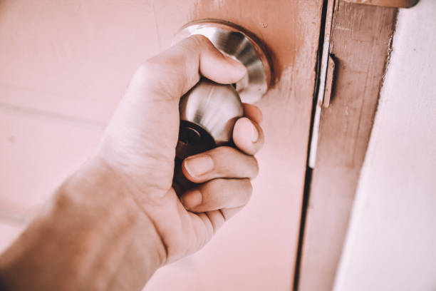 istock People are opening the door by key and hand 965547358
