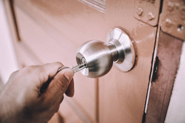 istock People are opening the door by key and hand 965547404