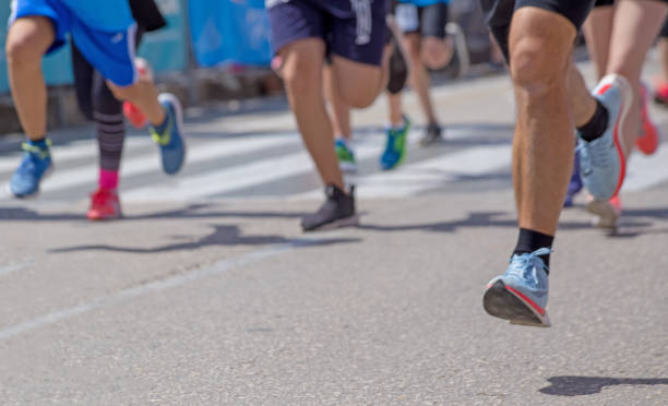 istock run athletes feet back race on asphalt action , background 965552452