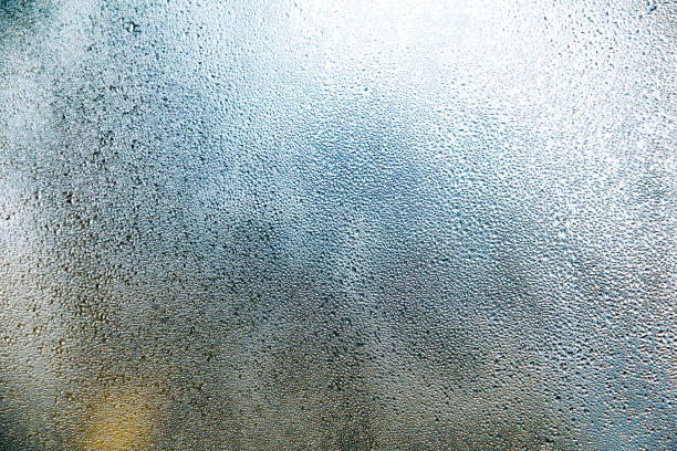 istock water vapor streams on window glass, abstract macro pattern texture background 965555552