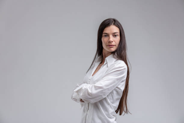 istock Long-haired brunette woman with arms crossed 965557626