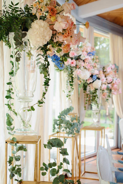 istock Wedding tables set for banquet or wedding event catering. Party celebration wedding concept. Flowers wedding decoration of tables for guests of bride and groom. Table appointment event 965560370