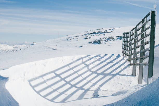 śnieżny zimowy krajobraz. wysoki drewniany płot na płaskowyżu odlewa cienia - skiing snow ski slope sunlight zdjęcia i obrazy z banku zdjęć