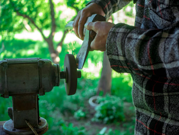 istock close up hand grinding axe outdoor with many sparkles 965566178