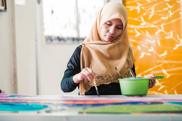 istock Asian woman working in Batik workshop 965566866