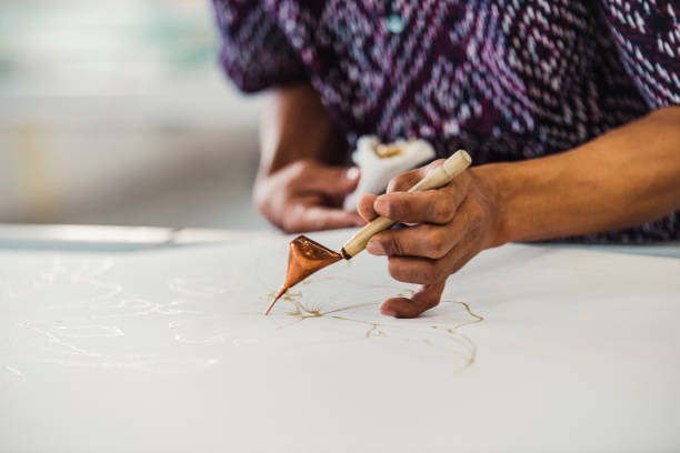 Asian man working in Batik workshop stock photo
