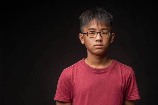 a asian teenager chinese boy looking at camera