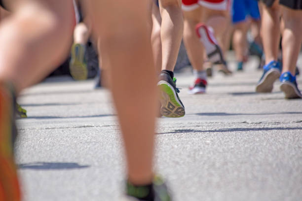 istock athlete foot feet back race on asphalt action , background 965573398