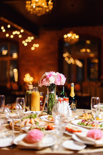 istock Wedding tables set for banquet or wedding event catering. Party celebration wedding concept. Flowers wedding decoration of tables for guests of bride and groom. Table appointment event 965573446