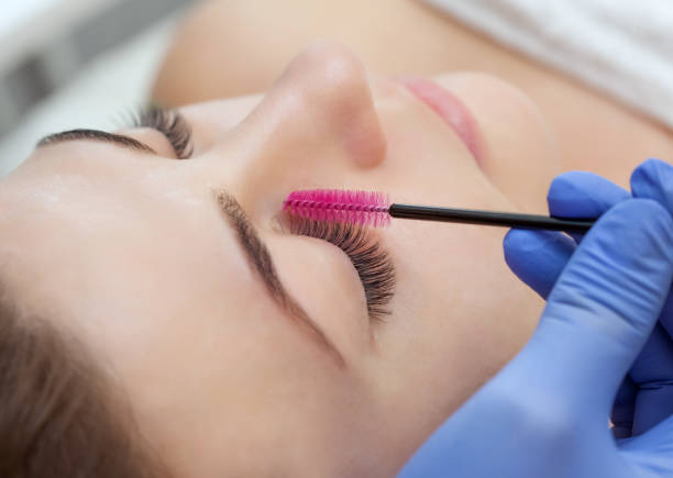 istock Eyelash extension procedure. Lashes close up 965580522
