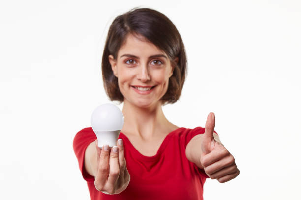 istock cute and beauty young woman holding light bulb 965581004