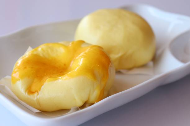 istock Steam Buns with cream on top in white plate 965581756