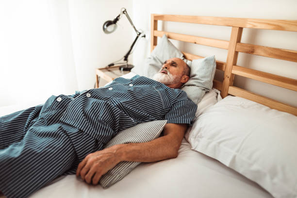 istock senior man wake up on the bed 965582596