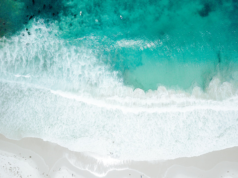 Aerial view of Waves Crashing on Sandy Beach