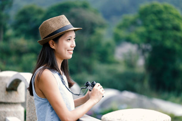 istock Woman tourist using telescope 965586242
