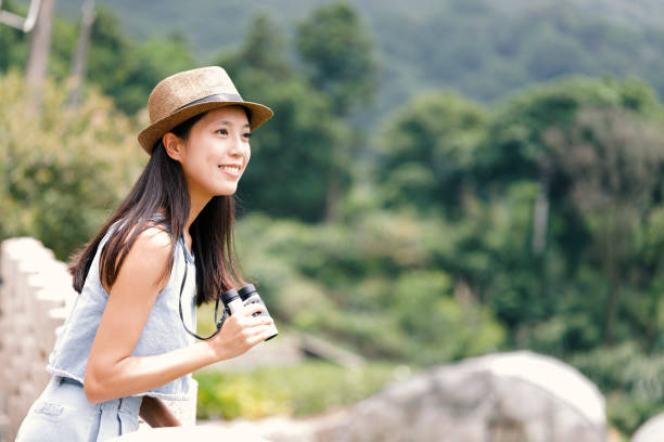 istock Woman tourist using telescope 965586490