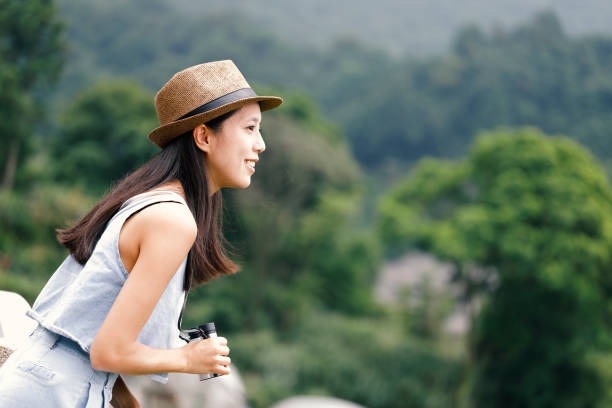 istock Woman tourist using telescope 965586654