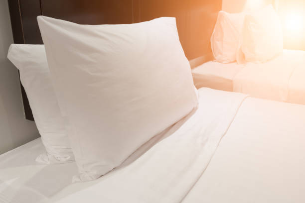istock White pillow in bedroom. Home decoration and relaxation concept. object theme. Orange light element 965586764