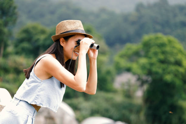 istock Woman tourist using telescope 965586860